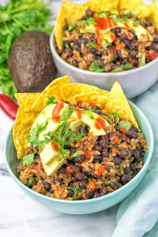 Zooming on the rice and bean mixture of the burrito filling.