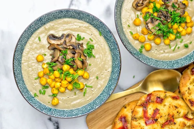 Top view on two bowls with the Roasted Chickpeas Cream of Mushroom Soup