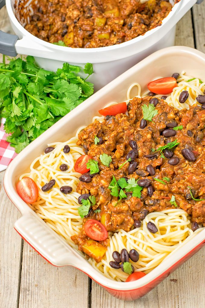 Vegetarian Cincinnati Chili over pasta in a casserole dish.