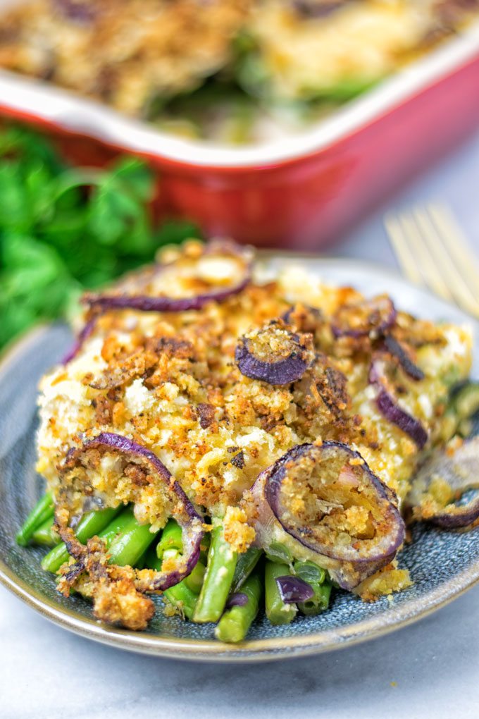 Green beans under a topping of mashed chickpeas and fried onions.