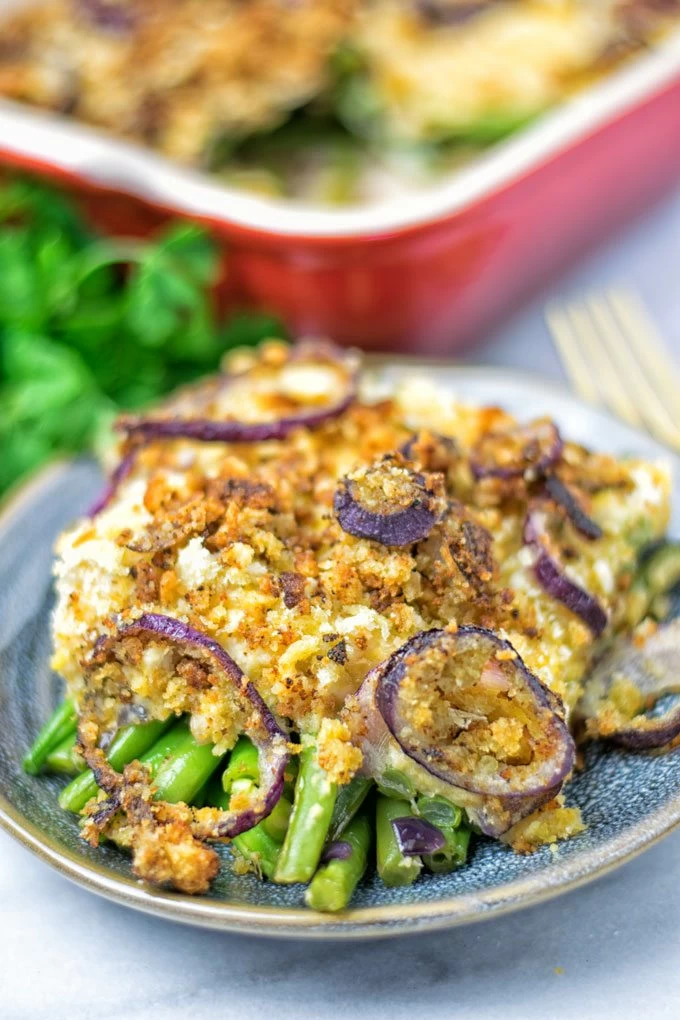 Green beans under a topping of mashed chickpeas and fried onions.