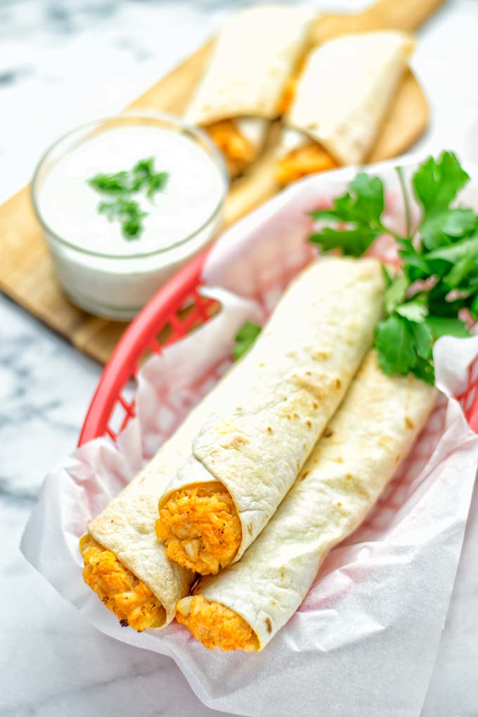 These Buffalo Cauliflower Taquitos are the ultimate comfort food. Vegan, gluten free, super easy to make and insanely delicious. An amazing dairy free alternative for dinner, lunch, potluck, party, meal prep, work lunch option. Once you’ll try these, they will go into your daily rotation. #vegan #glutenfree #vegetarian #dairyfree #plantbased #contentednesscooking #lunch #dinner #mealprep #worklunchideas #taquitos #buffalocauliflower #easyfood #budgetfriendly #makeahedmeals #cauliflower