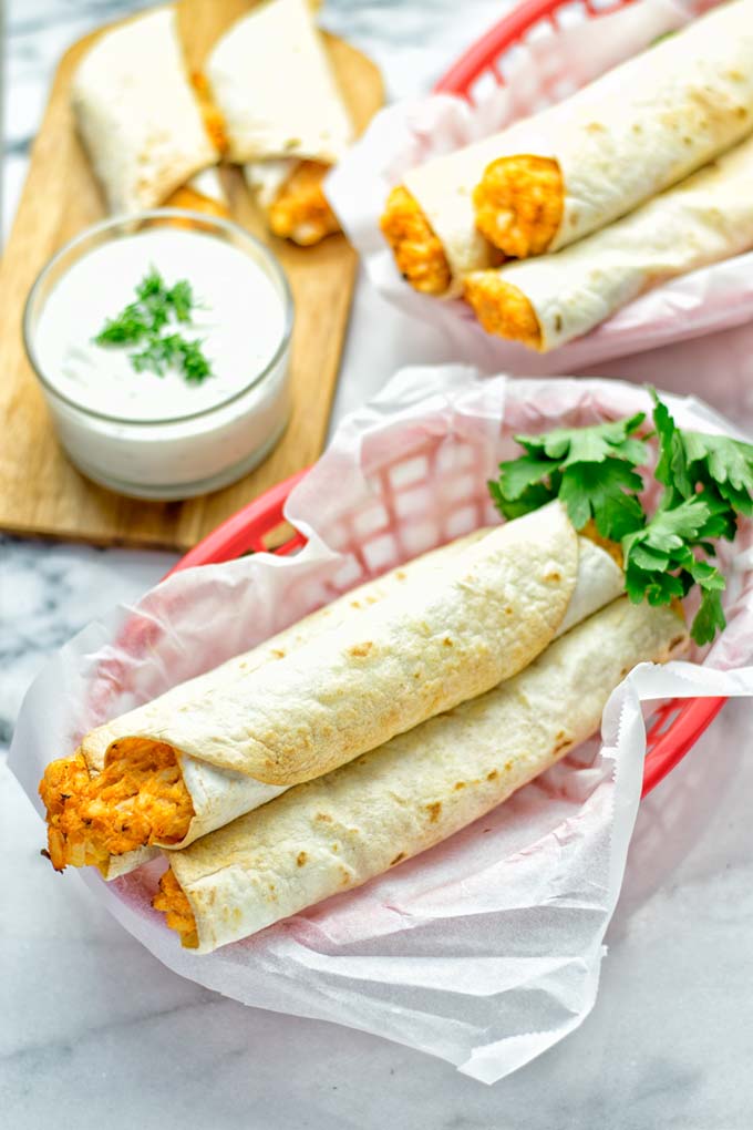 These Buffalo Cauliflower Taquitos are the ultimate comfort food. Vegan, gluten free, super easy to make and insanely delicious. An amazing dairy free alternative for dinner, lunch, potluck, party, meal prep, work lunch option. Once you’ll try these, they will go into your daily rotation. #vegan #glutenfree #vegetarian #dairyfree #plantbased #contentednesscooking #lunch #dinner #mealprep #worklunchideas #taquitos #buffalocauliflower #easyfood #budgetfriendly #makeahedmeals #cauliflower