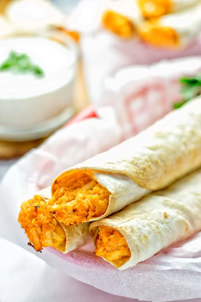 These Buffalo Cauliflower Taquitos are the ultimate comfort food. Vegan, gluten free, super easy to make and insanely delicious. An amazing dairy free alternative for dinner, lunch, potluck, party, meal prep, work lunch option. Once you’ll try these, they will go into your daily rotation. #vegan #glutenfree #vegetarian #dairyfree #plantbased #contentednesscooking #lunch #dinner #mealprep #worklunchideas #taquitos #buffalocauliflower #easyfood #budgetfriendly #makeahedmeals #cauliflower