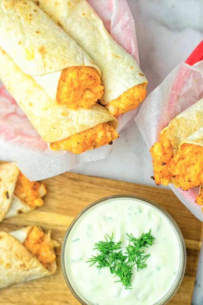 These Buffalo Cauliflower Taquitos are the ultimate comfort food. Vegan, gluten free, super easy to make and insanely delicious. An amazing dairy free alternative for dinner, lunch, potluck, party, meal prep, work lunch option. Once you’ll try these, they will go into your daily rotation. #vegan #glutenfree #vegetarian #dairyfree #plantbased #contentednesscooking #lunch #dinner #mealprep #worklunchideas #taquitos #buffalocauliflower #easyfood #budgetfriendly #makeahedmeals #cauliflower