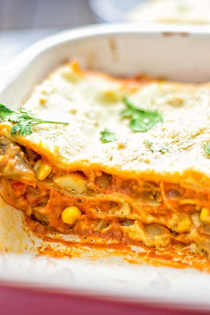 Super easy and delicious: This Enchilada Lasagna is naturally vegan, gluten free and a winning combination for any food lover. An amazing dairy free lunch, dinner, meal prep, work lunch and easy family dinner that will blow you away with just the right amount of flavor and spices. Come and try this fantastic dairy free alternative now, so good! #vegan #glutenfree #vegetarian #dairyfree #enchilada #lasagna #mealprep #worklunchideas #contentednesscooking #dinner #lunch #easyfamilyrecipes #easyfood