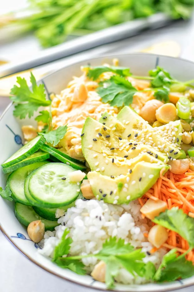 Easy and delicious: This Hawaiian Poke Bowl is naturally vegan, gluten free. Made with sushi rice, an amazing white cabbage mix with creamy sriracha sauce and edamame for protein richness. You can add options like shredded carrots, seaweed flakes, and more to build your dream bowl. Try it now and enjoy for lunch, dinner, meal prep! #vegan #glutenfree #vegetarian #dairyfree #contentednesscooking #dinner #lunch #pokebowl #hawaiianfood #easyfood #mealprep #budgetmeals #worklunchideas #bowlrecipes