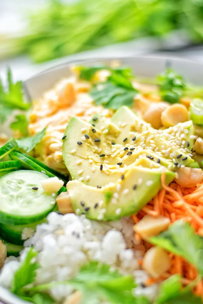 Easy and delicious: This Hawaiian Poke Bowl is naturally vegan, gluten free. Made with sushi rice, an amazing white cabbage mix with creamy sriracha sauce and edamame for protein richness. You can add options like shredded carrots, seaweed flakes, and more to build your dream bowl. Try it now and enjoy for lunch, dinner, meal prep! #vegan #glutenfree #vegetarian #dairyfree #contentednesscooking #dinner #lunch #pokebowl #hawaiianfood #easyfood #mealprep #budgetmeals #worklunchideas #bowlrecipes