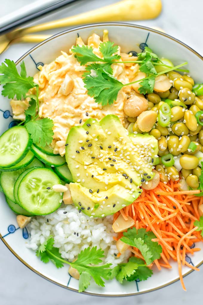 Easy and delicious: This Hawaiian Poke Bowl is naturally vegan, gluten free. Made with sushi rice, an amazing white cabbage mix with creamy sriracha sauce and edamame for protein richness. You can add options like shredded carrots, seaweed flakes, and more to build your dream bowl. Try it now and enjoy for lunch, dinner, meal prep! #vegan #glutenfree #vegetarian #dairyfree #contentednesscooking #dinner #lunch #pokebowl #hawaiianfood #easyfood #mealprep #budgetmeals #worklunchideas #bowlrecipes