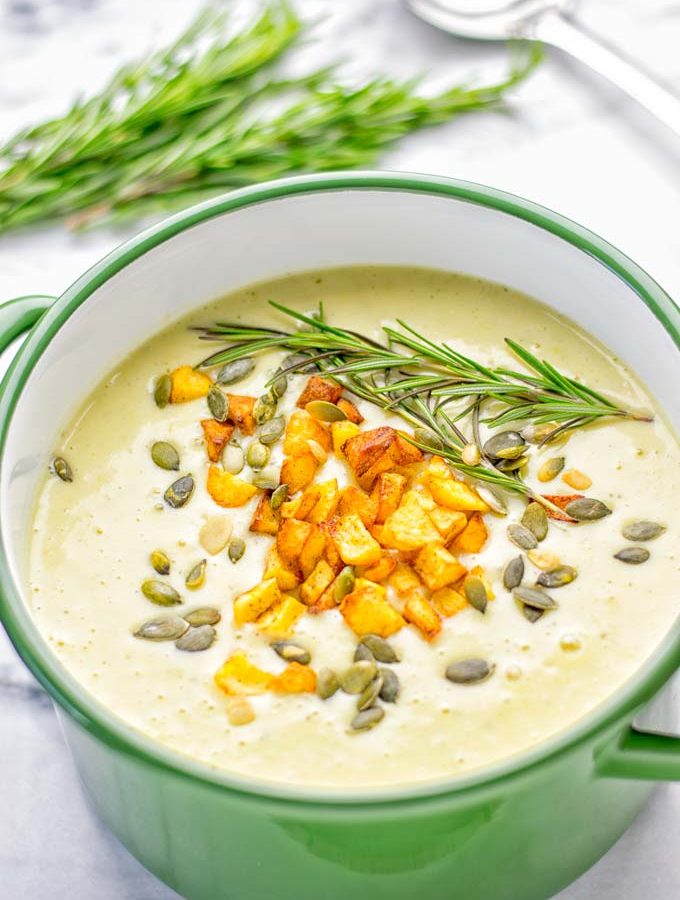 This Cheesy Potato Soup with Roasted Pepitas is the ultimate comfort food for everyone. Entirely vegan, gluten free, super easy to make. Such a delicious option for lunch, dinner, meal prep, work lunches and of course perfect for holidays. #vegan #glutenfree #dairyfree #vegetarian #soup #potatoes #holidays #dinner #lunch #mealprep Worklunchideas #contentednesscooking #potatosoup #familymealsonabudget #familymealskidfriendly