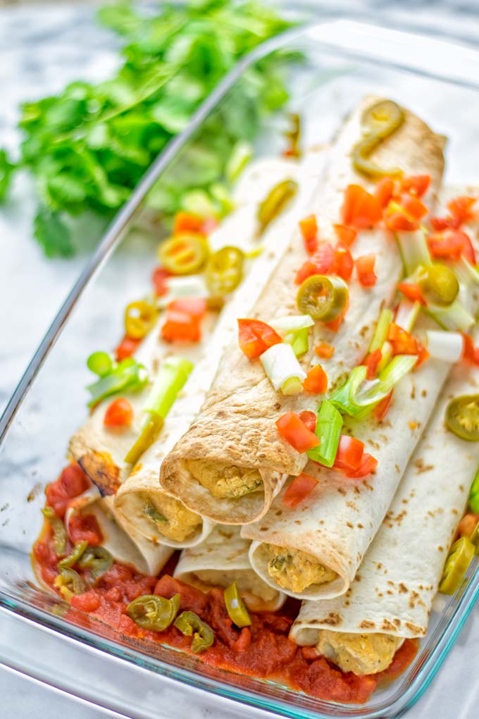 These Green Chili Enchiladas are entirely vegan, gluten free, super easy to make and so delicious. An amazing dairy free alternative for dinner, lunch, meal preparation, work lunch, potlucks, parties and so much more that the whole family will love. #vegan #glutenfree #dairyfree #contentednesscooking #dinner #lunch #mealprep #worklunchideas #easyfood #enchiladas #vegetarian #potluckrecipes #partyfood #mexican #greenchilirecipes