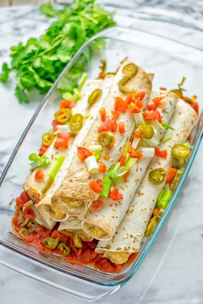 These Green Chili Enchiladas are entirely vegan, gluten free, super easy to make and so delicious. An amazing dairy free alternative for dinner, lunch, meal preparation, work lunch, potlucks, parties and so much more that the whole family will love. #vegan #glutenfree #dairyfree #contentednesscooking #dinner #lunch #mealprep #worklunchideas #easyfood #enchiladas #vegetarian #potluckrecipes #partyfood #mexican #greenchilirecipes