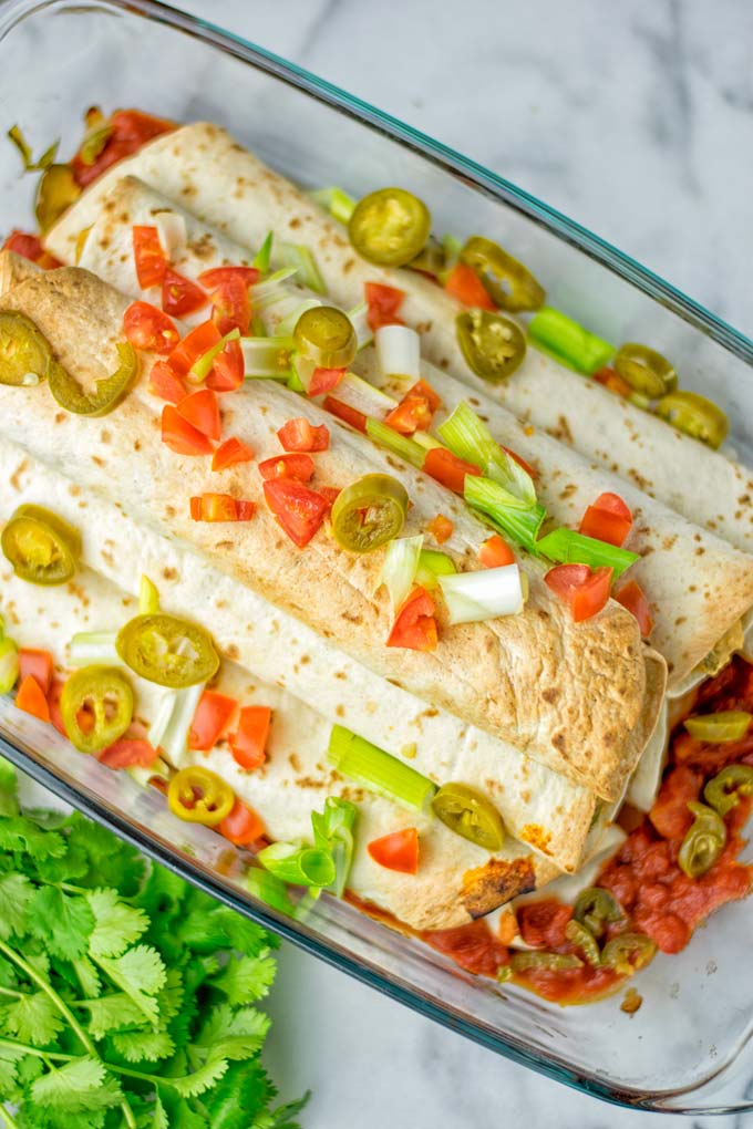 These Green Chili Enchiladas are entirely vegan, gluten free, super easy to make and so delicious. An amazing dairy free alternative for dinner, lunch, meal preparation, work lunch, potlucks, parties and so much more that the whole family will love. #vegan #glutenfree #dairyfree #contentednesscooking #dinner #lunch #mealprep #worklunchideas #easyfood #enchiladas #vegetarian #potluckrecipes #partyfood #mexican #greenchilirecipes