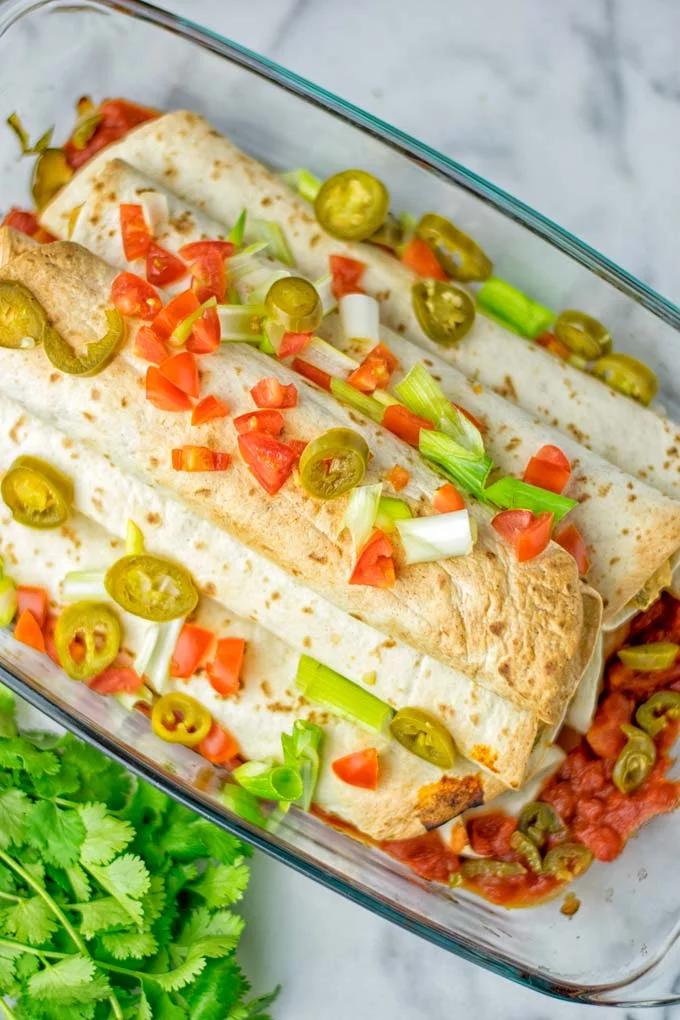 These Green Chili Enchiladas are entirely vegan, gluten free, super easy to make and so delicious. An amazing dairy free alternative for dinner, lunch, meal preparation, work lunch, potlucks, parties and so much more that the whole family will love. #vegan #glutenfree #dairyfree #contentednesscooking #dinner #lunch #mealprep #worklunchideas #easyfood #enchiladas #vegetarian #potluckrecipes #partyfood #mexican #greenchilirecipes