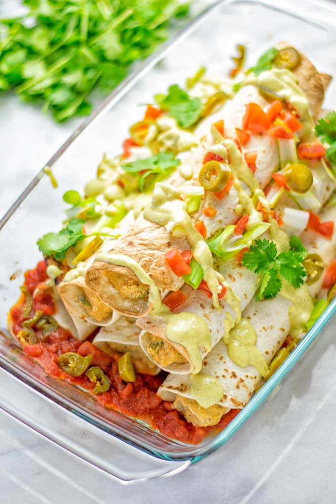 These Green Chili Enchiladas are entirely vegan, gluten free, super easy to make and so delicious. An amazing dairy free alternative for dinner, lunch, meal preparation, work lunch, potlucks, parties and so much more that the whole family will love. #vegan #glutenfree #dairyfree #contentednesscooking #dinner #lunch #mealprep #worklunchideas #easyfood #enchiladas #vegetarian #potluckrecipes #partyfood #mexican #greenchilirecipes