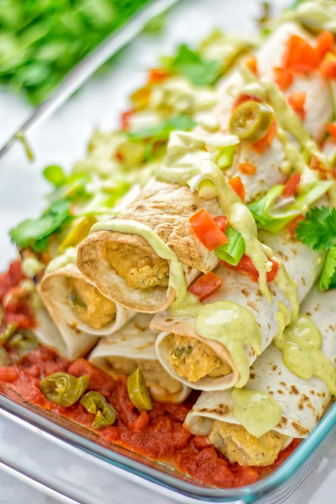 These Green Chili Enchiladas are entirely vegan, gluten free, super easy to make and so delicious. An amazing dairy free alternative for dinner, lunch, meal preparation, work lunch, potlucks, parties and so much more that the whole family will love. #vegan #glutenfree #dairyfree #contentednesscooking #dinner #lunch #mealprep #worklunchideas #easyfood #enchiladas #vegetarian #potluckrecipes #partyfood #mexican #greenchilirecipes