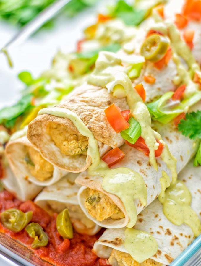 These Green Chili Enchiladas are entirely vegan, gluten free, super easy to make and so delicious. An amazing dairy free alternative for dinner, lunch, meal preparation, work lunch, potlucks, parties and so much more that the whole family will love. #vegan #glutenfree #dairyfree #contentednesscooking #dinner #lunch #mealprep #worklunchideas #easyfood #enchiladas #vegetarian #potluckrecipes #partyfood #mexican #greenchilirecipes
