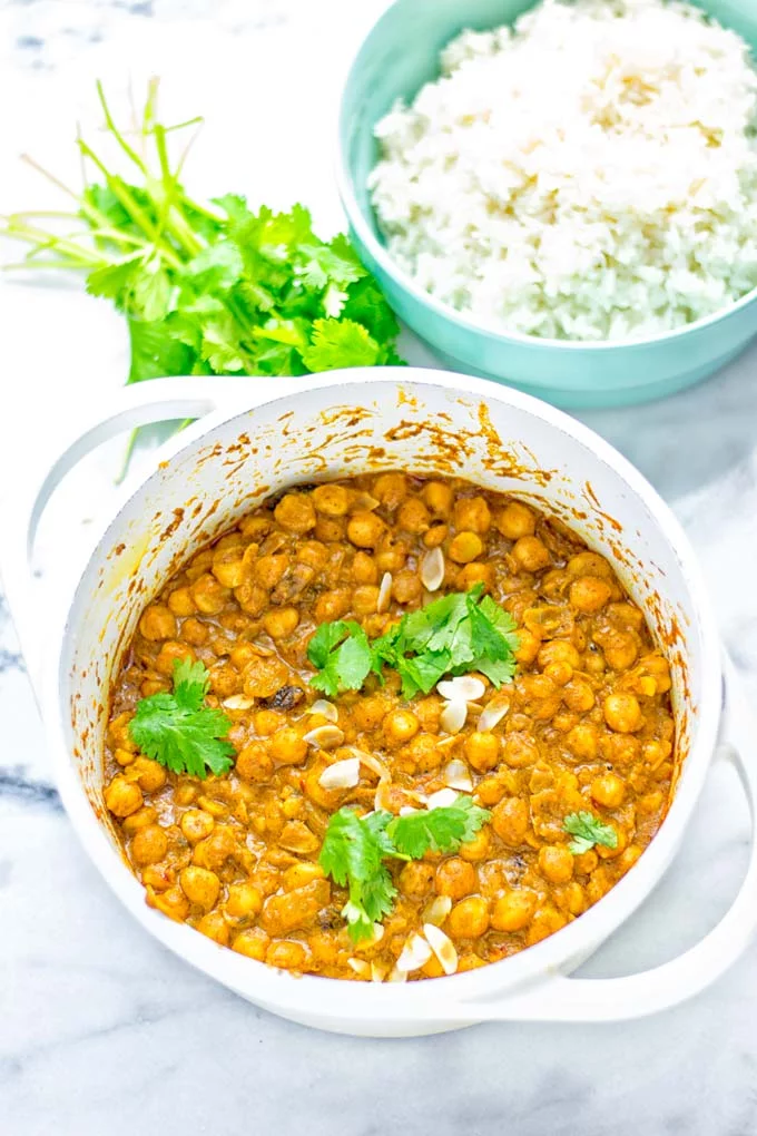 Insanely delicious One Pot Chickpea Biryani full of amazing flavors and naturally vegan, gluten free. An easy dish which is perfect for lunch, dinner, meal prep and work lunch. If you’re looking for a super easy biryani try it now. #vegan #glutenfree #dairyfree #vegetarian #chickpeas #chickpeabiryani #biryani #onepotmeals #mealprep #worklunchideas #dinner #lunch #contentednesscooking