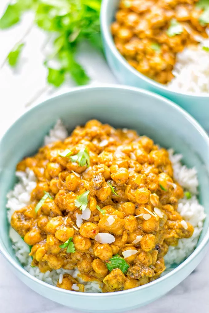 Insanely delicious One Pot Chickpea Biryani full of amazing flavors and naturally vegan, gluten free. An easy dish which is perfect for lunch, dinner, meal prep and work lunch. If you’re looking for a super easy biryani try it now. #vegan #glutenfree #dairyfree #vegetarian #chickpeas #chickpeabiryani #biryani #onepotmeals #mealprep #worklunchideas #dinner #lunch #contentednesscooking