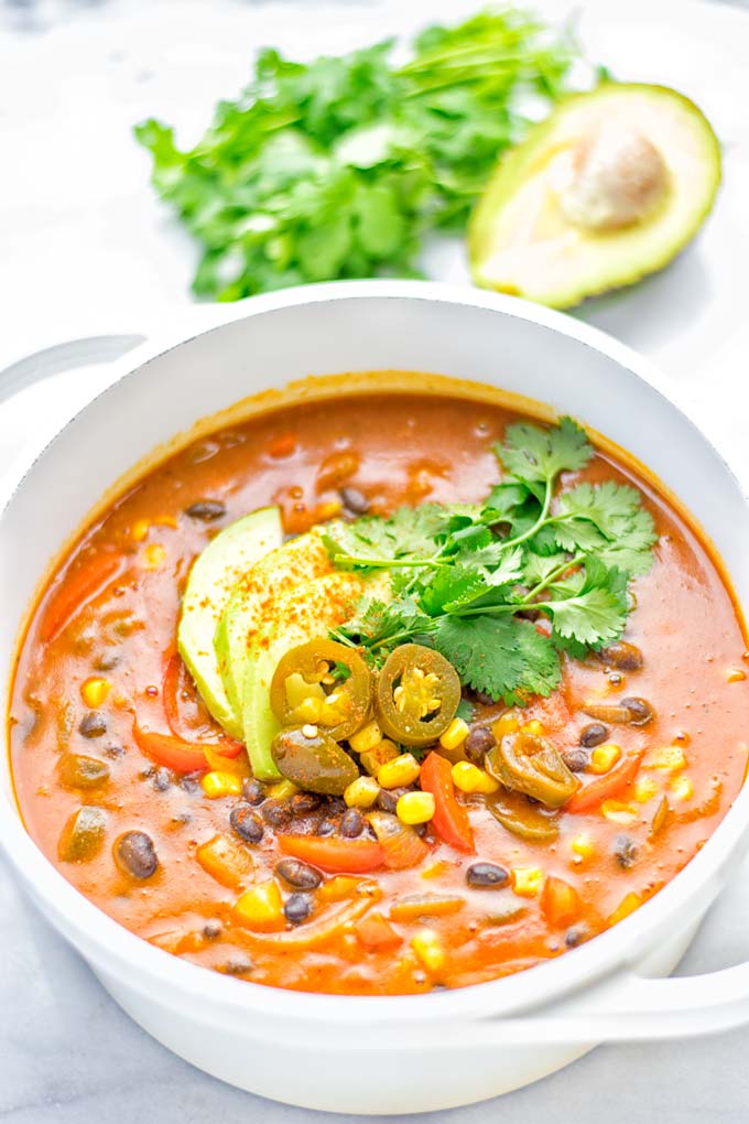 This Spicy Garlic Enchilada Soup is made in one pot, insanely delicious and super easy to make. Naturally vegan, gluten free and amazing for dinner, lunch, meal prep and work lunch. Try it now you won't believe how easy it is! #vegan #glutenfree #dairyfree # vegetarian #enchilada #soup #dinner #lunch #mealprep #worklunchideas #onepotmeals #enchiladasoup #contentednesscooking 