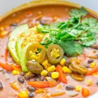 This Spicy Garlic Enchilada Soup is made in one pot, insanely delicious and super easy to make. Naturally vegan, gluten free and amazing for dinner, lunch, meal prep and work lunch. Try it now you won't believe how easy it is! #vegan #glutenfree #dairyfree # vegetarian #enchilada #soup #dinner #lunch #mealprep #worklunchideas #onepotmeals #enchiladasoup #contentednesscooking