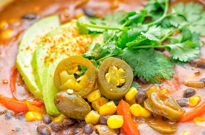 This Spicy Garlic Enchilada Soup is made in one pot, insanely delicious and super easy to make. Naturally vegan, gluten free and amazing for dinner, lunch, meal prep and work lunch. Try it now you won't believe how easy it is! #vegan #glutenfree #dairyfree # vegetarian #enchilada #soup #dinner #lunch #mealprep #worklunchideas #onepotmeals #enchiladasoup #contentednesscooking