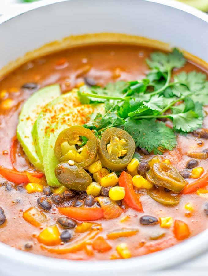 This Spicy Garlic Enchilada Soup is made in one pot, insanely delicious and super easy to make. Naturally vegan, gluten free and amazing for dinner, lunch, meal prep and work lunch. Try it now you won't believe how easy it is! #vegan #glutenfree #dairyfree # vegetarian #enchilada #soup #dinner #lunch #mealprep #worklunchideas #onepotmeals #enchiladasoup #contentednesscooking