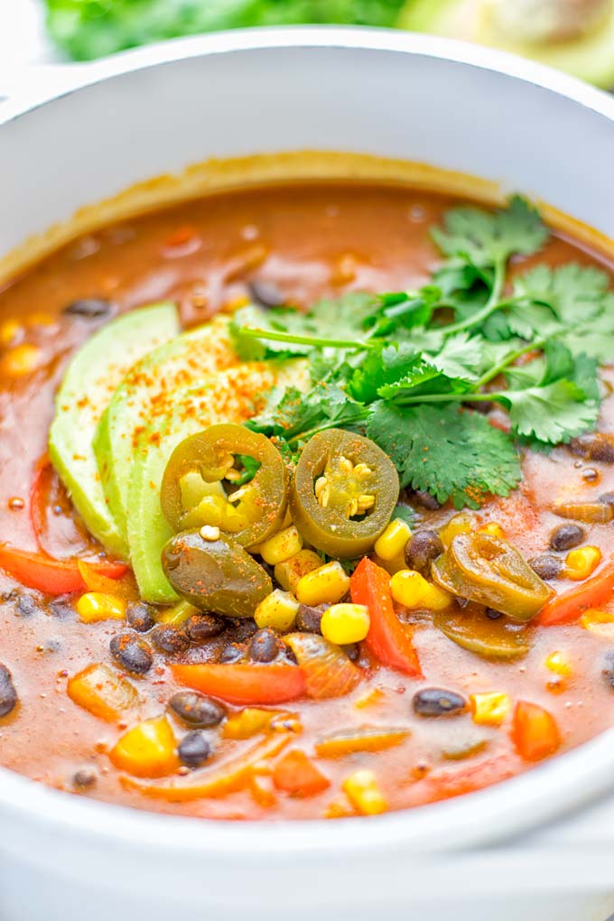 This Spicy Garlic Enchilada Soup is made in one pot, insanely delicious and super easy to make. Naturally vegan, gluten free and amazing for dinner, lunch, meal prep and work lunch. Try it now you won't believe how easy it is! #vegan #glutenfree #dairyfree # vegetarian #enchilada #soup #dinner #lunch #mealprep #worklunchideas #onepotmeals #enchiladasoup #contentednesscooking 