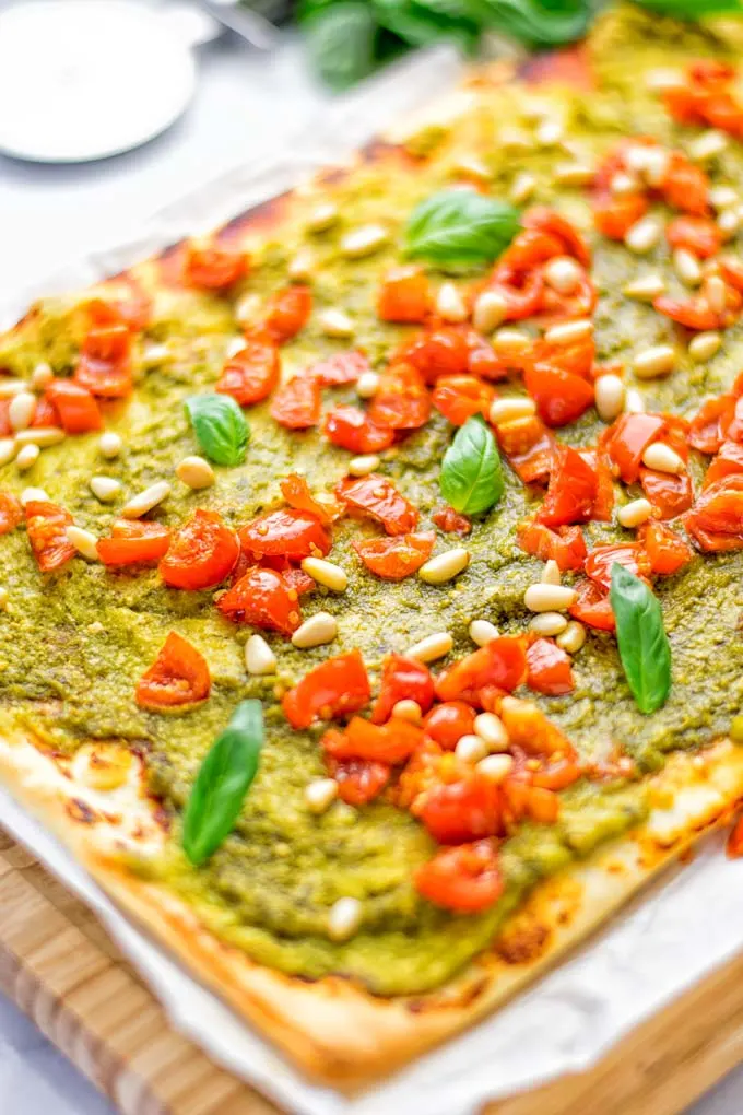 This White Bean and Pesto Pizza is super easy to make, entirely vegan and gluten free. If you love pizza and pesto you’re coming to the right place. It’s so delicious for lunch, dinner, meal preparation, and work lunch. Try it now and fall in love. #vegan #glutenfree #dairyfree #contentednesscooking #pesto #pizza #mealprep #worklunchideas #easyfood #lunch #dinner