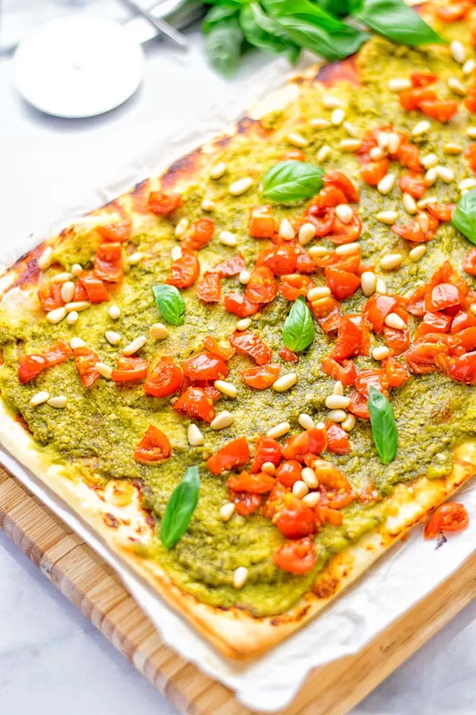 This White Bean and Pesto Pizza is super easy to make, entirely vegan and gluten free. If you love pizza and pesto you’re coming to the right place. It’s so delicious for lunch, dinner, meal preparation, and work lunch. Try it now and fall in love. #vegan #glutenfree #dairyfree #contentednesscooking #pesto #pizza #mealprep #worklunchideas #easyfood #lunch #dinner