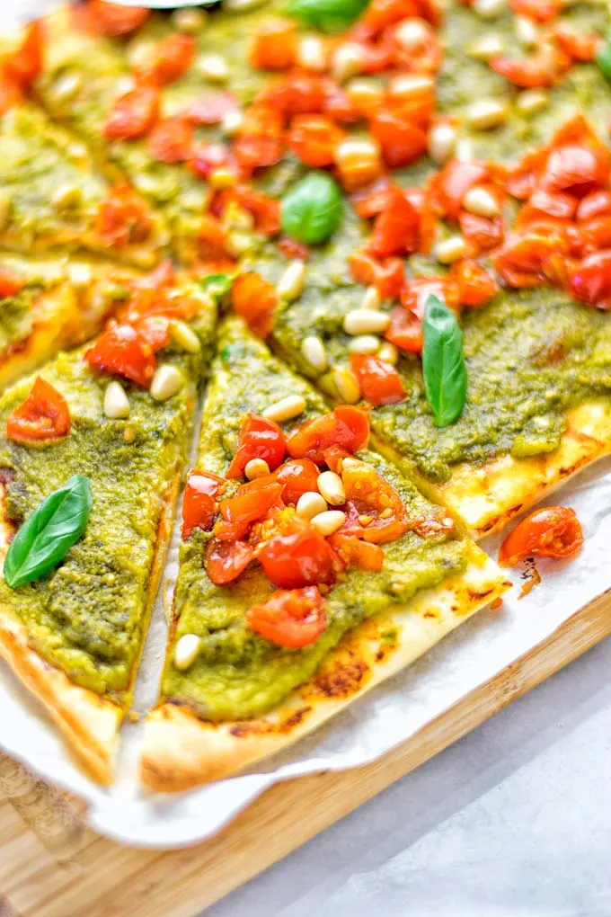 This White Bean and Pesto Pizza is super easy to make, entirely vegan and gluten free. If you love pizza and pesto you’re coming to the right place. It’s so delicious for lunch, dinner, meal preparation, and work lunch. Try it now and fall in love. #vegan #glutenfree #dairyfree #contentednesscooking #pesto #pizza #mealprep #worklunchideas #easyfood #lunch #dinner