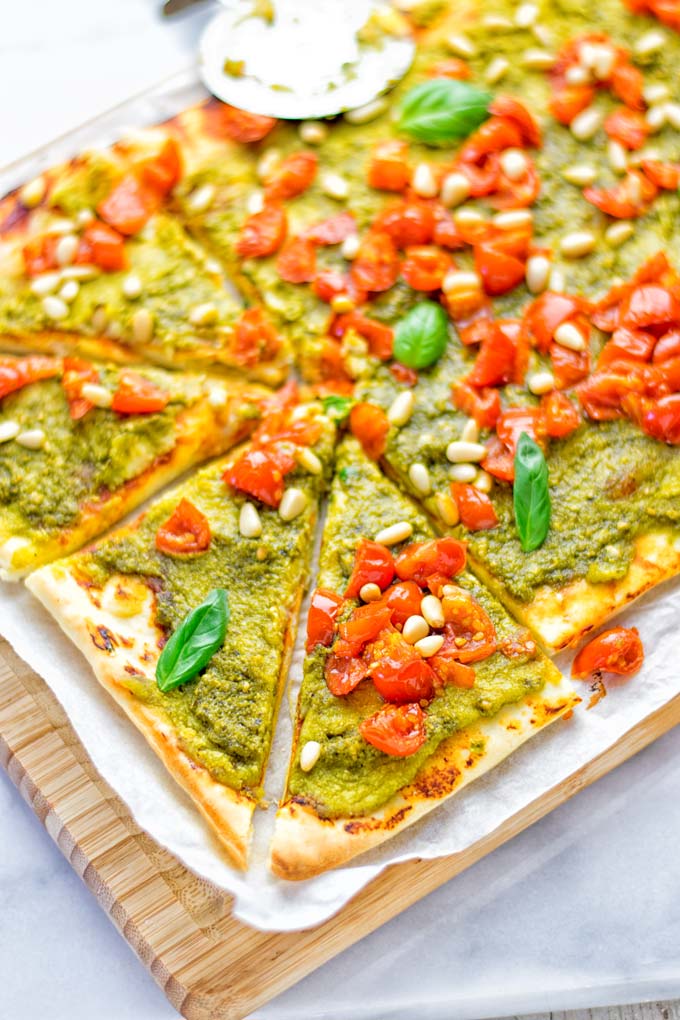 This White Bean and Pesto Pizza is super easy to make, entirely vegan and gluten free. If you love pizza and pesto you’re coming to the right place. It’s so delicious for lunch, dinner, meal preparation, and work lunch. Try it now and fall in love. #vegan #glutenfree #dairyfree #contentednesscooking #pesto #pizza #mealprep #worklunchideas #easyfood #lunch #dinner