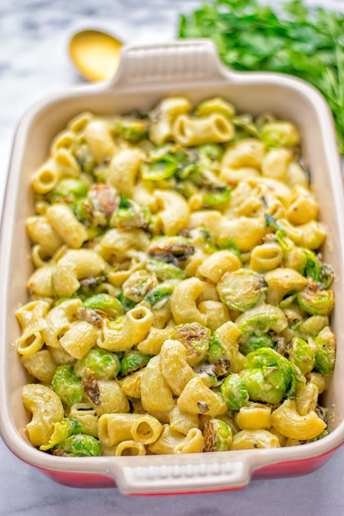 This Garlic Brussels Sprouts Mac and Cheese is entirely vegan, gluten free, and super easy to make. It’s an amazing comfort food for dinner, lunch, meal prep, work lunches, date nights and of course the holidays. Everyone will get addicted to this from the first to the last bite, try it now! #vegan #glutenfree #dairyfree #vegetarian #mealprep #dinner #lunch #worklunchideas #holidays #macandcheese #contentednesscooking #pasta #thanksgiving 