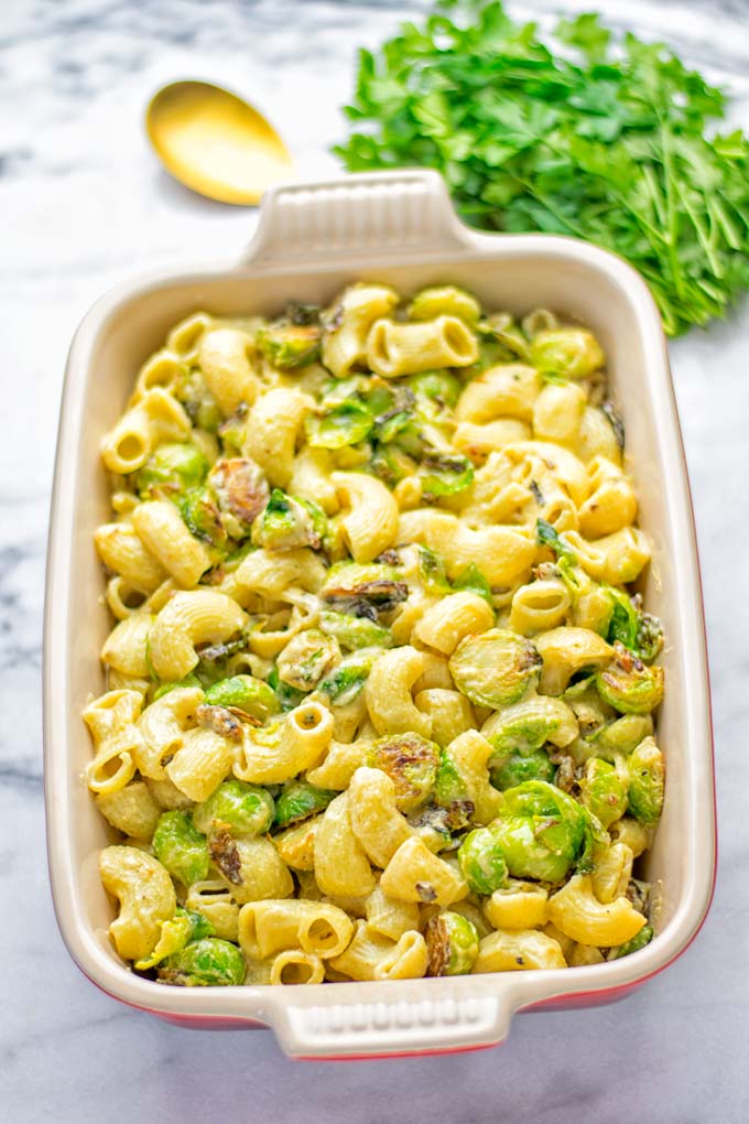 This Garlic Brussels Sprouts Mac and Cheese is entirely vegan, gluten free, and super easy to make. It’s an amazing comfort food for dinner, lunch, meal prep, work lunches, date nights and of course the holidays. Everyone will get addicted to this from the first to the last bite, try it now! #vegan #glutenfree #dairyfree #vegetarian #mealprep #dinner #lunch #worklunchideas #holidays #macandcheese #contentednesscooking #pasta #thanksgiving 