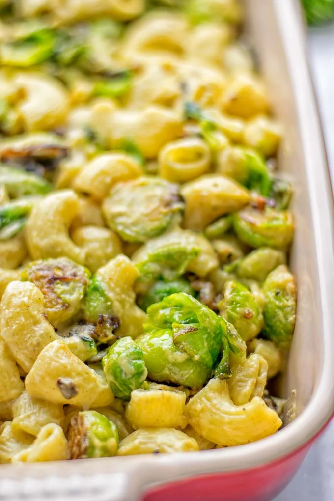 This Garlic Brussels Sprouts Mac and Cheese is entirely vegan, gluten free, and super easy to make. It’s an amazing comfort food for dinner, lunch, meal prep, work lunches, date nights and of course the holidays. Everyone will get addicted to this from the first to the last bite, try it now! #vegan #glutenfree #dairyfree #vegetarian #mealprep #dinner #lunch #worklunchideas #holidays #macandcheese #contentednesscooking #pasta #thanksgiving 