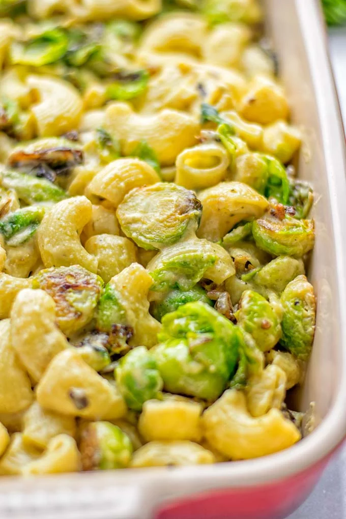 This Garlic Brussels Sprouts Mac and Cheese is entirely vegan, gluten free, and super easy to make. It’s an amazing comfort food for dinner, lunch, meal prep, work lunches, date nights and of course the holidays. Everyone will get addicted to this from the first to the last bite, try it now! #vegan #glutenfree #dairyfree #vegetarian #mealprep #dinner #lunch #worklunchideas #holidays #macandcheese #contentednesscooking #pasta #thanksgiving 