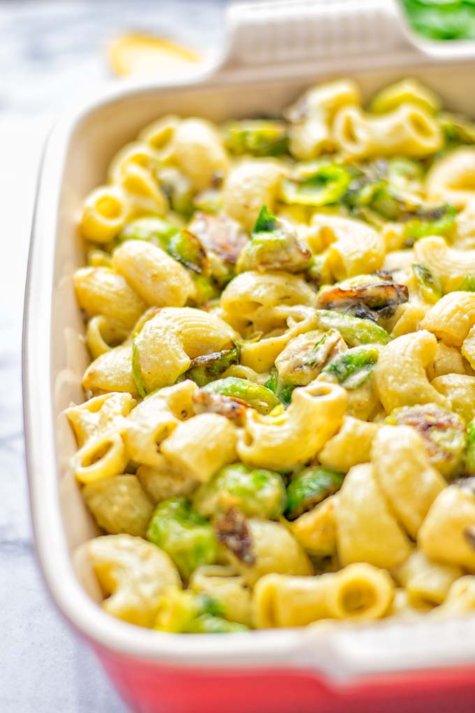 This Garlic Brussels Sprouts Mac and Cheese is entirely vegan, gluten free, and super easy to make. It’s an amazing comfort food for dinner, lunch, meal prep, work lunches, date nights and of course the holidays. Everyone will get addicted to this from the first to the last bite, try it now! #vegan #glutenfree #dairyfree #vegetarian #mealprep #dinner #lunch #worklunchideas #holidays #macandcheese #contentednesscooking #pasta #thanksgiving 