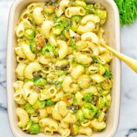 This Garlic Brussels Sprouts Mac and Cheese is entirely vegan, gluten free, and super easy to make. It’s an amazing comfort food for dinner, lunch, meal prep, work lunches, date nights and of course the holidays. Everyone will get addicted to this from the first to the last bite, try it now! #vegan #glutenfree #dairyfree #vegetarian #mealprep #dinner #lunch #worklunchideas #holidays #macandcheese #contentednesscooking #pasta #thanksgiving