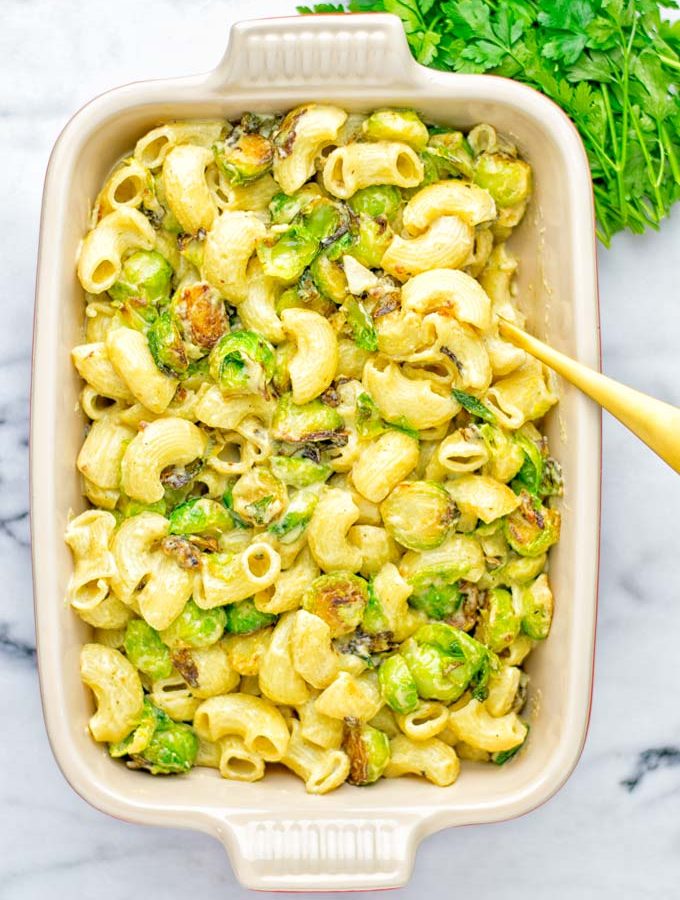 This Garlic Brussels Sprouts Mac and Cheese is entirely vegan, gluten free, and super easy to make. It’s an amazing comfort food for dinner, lunch, meal prep, work lunches, date nights and of course the holidays. Everyone will get addicted to this from the first to the last bite, try it now! #vegan #glutenfree #dairyfree #vegetarian #mealprep #dinner #lunch #worklunchideas #holidays #macandcheese #contentednesscooking #pasta #thanksgiving