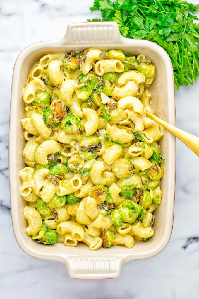 This Garlic Brussels Sprouts Mac and Cheese is entirely vegan, gluten free, and super easy to make. It’s an amazing comfort food for dinner, lunch, meal prep, work lunches, date nights and of course the holidays. Everyone will get addicted to this from the first to the last bite, try it now! #vegan #glutenfree #dairyfree #vegetarian #mealprep #dinner #lunch #worklunchideas #holidays #macandcheese #contentednesscooking #pasta #thanksgiving 