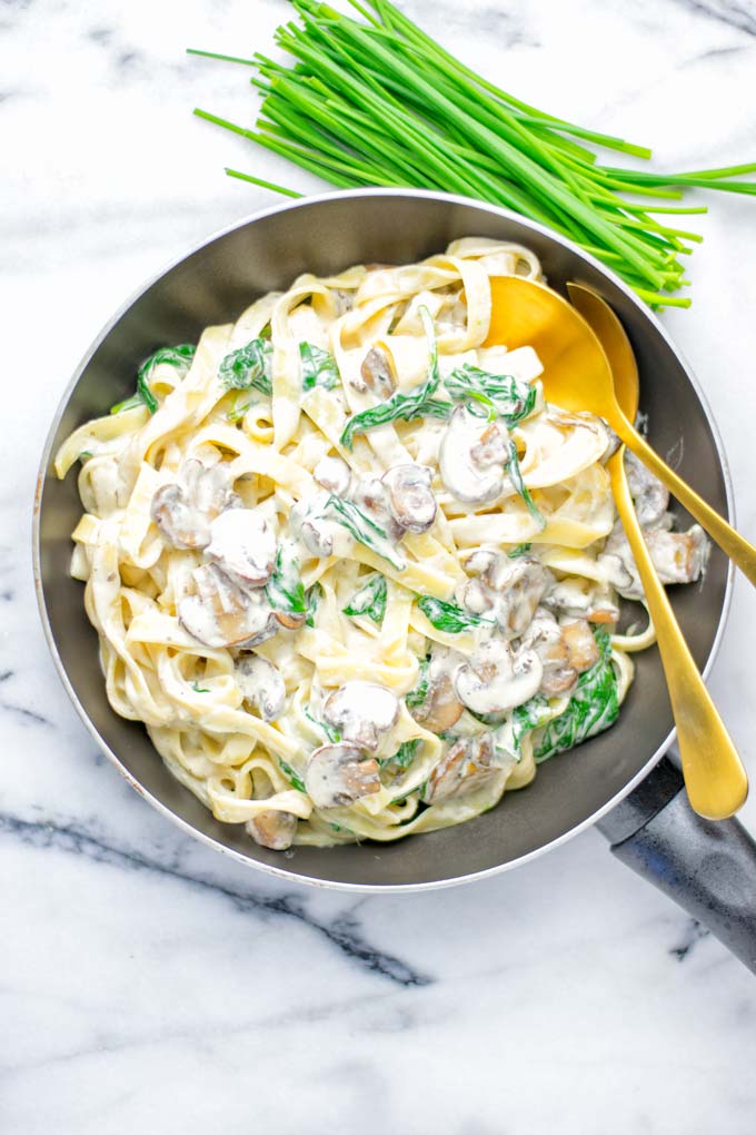 Super creamy and easy to make: Spinach Mushroom Fettuccine Alfredo entirely vegan, gluten free and the ultimate comfort food for dinner, lunch, meal preparation that the whole family will love. If you’re looking for a delicious fettuccine Alfredo recipe try it now, it’s a keeper. #vegan #glutenfree #dairyfree #vegetarian #contentednesscooking #dinner #lunch #mealprep #worklunchideas #fettuccinealfredo #spinachrecipes #mushroomrecipes #familydinnerideas #fettuccinerecipes #easy20minutemeals