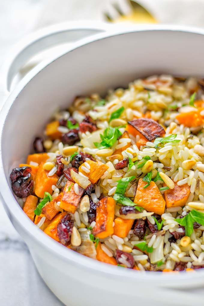 This Wild Rice Pilaf is a super easy and tasty one pot meal. Naturally vegan, gluten free it has all the flavors you love and want for Christmas and the whole year. Try it now for dinner, lunch, meal prep, wow your guests and family. #vegan #glutenfree #dairyfree #vegetarian #christmasfood #dinner #lunch #onepotmeals #holidayfood #wildricepilaf #ricepilafeasy #worklunchideas #contentednesscooking #mealprep 