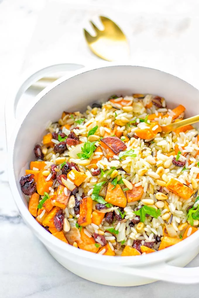 This Wild Rice Pilaf is a super easy and tasty one pot meal. Naturally vegan, gluten free it has all the flavors you love and want for Christmas and the whole year. Try it now for dinner, lunch, meal prep, wow your guests and family. #vegan #glutenfree #dairyfree #vegetarian #christmasfood #dinner #lunch #onepotmeals #holidayfood #wildricepilaf #ricepilafeasy #worklunchideas #contentednesscooking #mealprep 