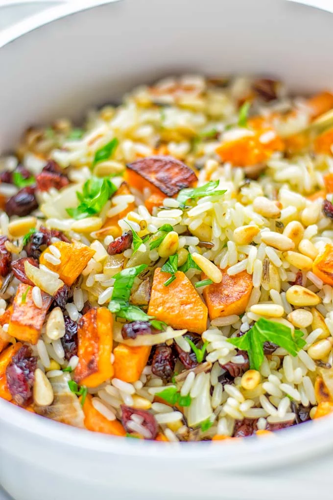 This Wild Rice Pilaf is a super easy and tasty one pot meal. Naturally vegan, gluten free it has all the flavors you love and want for Christmas and the whole year. Try it now for dinner, lunch, meal prep, wow your guests and family. #vegan #glutenfree #dairyfree #vegetarian #christmasfood #dinner #lunch #onepotmeals #holidayfood #wildricepilaf #ricepilafeasy #worklunchideas #contentednesscooking #mealprep 