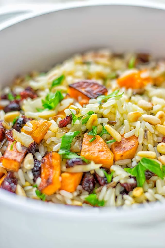 This Wild Rice Pilaf is a super easy and tasty one pot meal. Naturally vegan, gluten free it has all the flavors you love and want for Christmas and the whole year. Try it now for dinner, lunch, meal prep, wow your guests and family. #vegan #glutenfree #dairyfree #vegetarian #christmasfood #dinner #lunch #onepotmeals #holidayfood #wildricepilaf #ricepilafeasy #worklunchideas #contentednesscooking #mealprep 