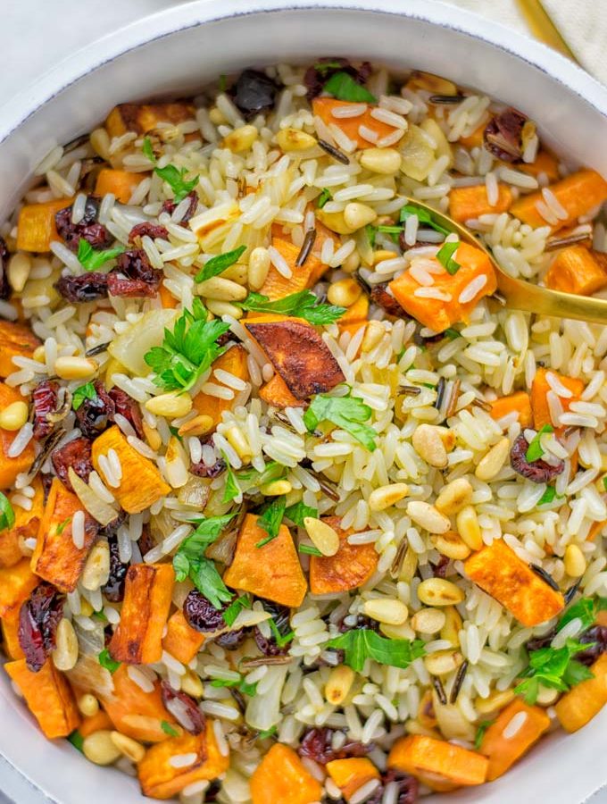 This Wild Rice Pilaf is a super easy and tasty one pot meal. Naturally vegan, gluten free it has all the flavors you love and want for Christmas and the whole year. Try it now for dinner, lunch, meal prep, wow your guests and family. #vegan #glutenfree #dairyfree #vegetarian #christmasfood #dinner #lunch #onepotmeals #holidayfood #wildricepilaf #ricepilafeasy #worklunchideas #contentednesscooking #mealprep