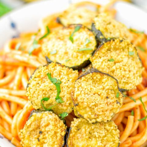 This Baked Zucchini Parmesan is entirely vegan, gluten free and will be a family favorite. Serve it with pasta, dips, as appetizer, dinner, lunches, meal preparation, or work lunch. Sprinkled with the best dairy free parmesan cheese that makes all the difference. Try it now. #vegan #dairyfree #vegetarian #contentednesscooking #dinner #lunch #mealprep #worklunchideas #zucchiniparmesan #zucchiniparmesanbaked #zucchiniparmesancrisps #comfortfood #kidfriendlydinners #familydinnerideas