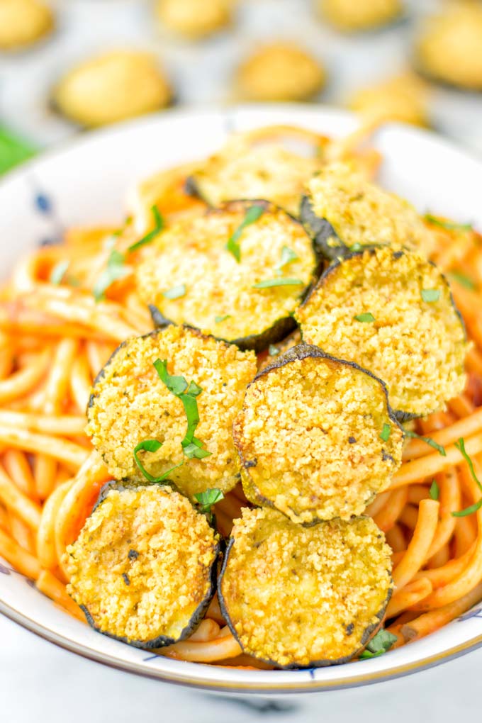 This Baked Zucchini Parmesan is entirely vegan, gluten free and will be a family favorite. Serve it with pasta, dips, as appetizer, dinner, lunches, meal preparation, or work lunch. Sprinkled with the best dairy free parmesan cheese that makes all the difference. Try it now. #vegan #dairyfree #vegetarian #contentednesscooking #dinner #lunch #mealprep #worklunchideas #zucchiniparmesan #zucchiniparmesanbaked #zucchiniparmesancrisps #comfortfood #kidfriendlydinners #familydinnerideas 