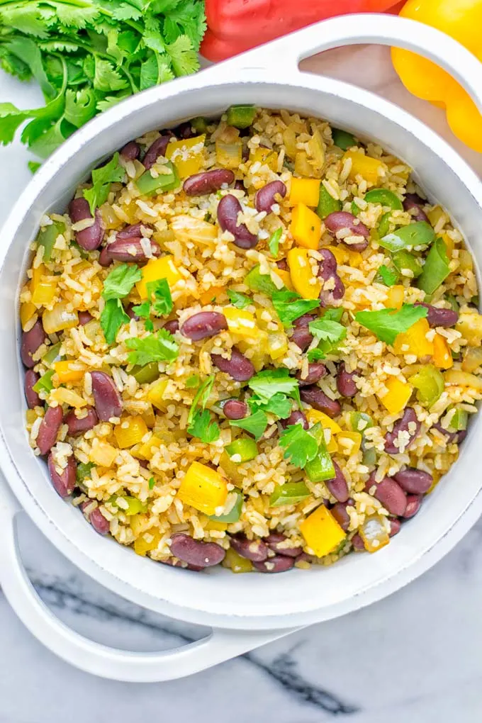 This Cajun Red Beans and Rice is an amazing one pot meal which is naturally vegan, gluten free. It’s packed with bold and fantastic flavors the whole family will love for dinner, lunch, meal prep and work lunch and so much more. Once you’ve tried this you can’t stop eating it so easy to make! #vegan #dairyfree #glutenfree #vegetarian #onepotmeals #dinner #lunch #worklunchideas #budgetmeals #contentednesscooking #cajunbeansandrice #mealprep 