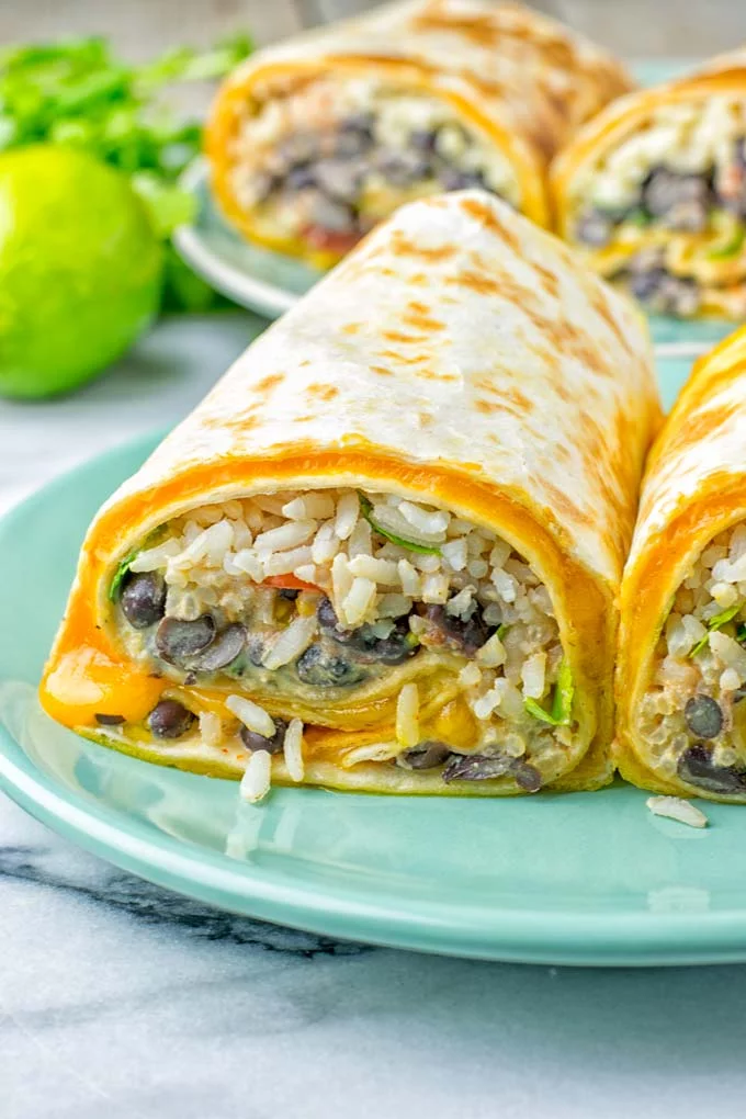 This Rice and Beans Quesarito is entirelly vegan, gluten free and so easy to make. It’s cheesy, incredibly satisfying and so delicious for dinner, lunch, meal prep (reheat beautifully) and amazing for work lunches. An amazing dairy free alternative for everyone that the whole family will love. #vegan #glutenfree #dairyfree #vegetarian #contentednesscooking #quesarito #riceandbeans #dinner #lunch #worklunchideas #mealprep #quesadila #burrito 